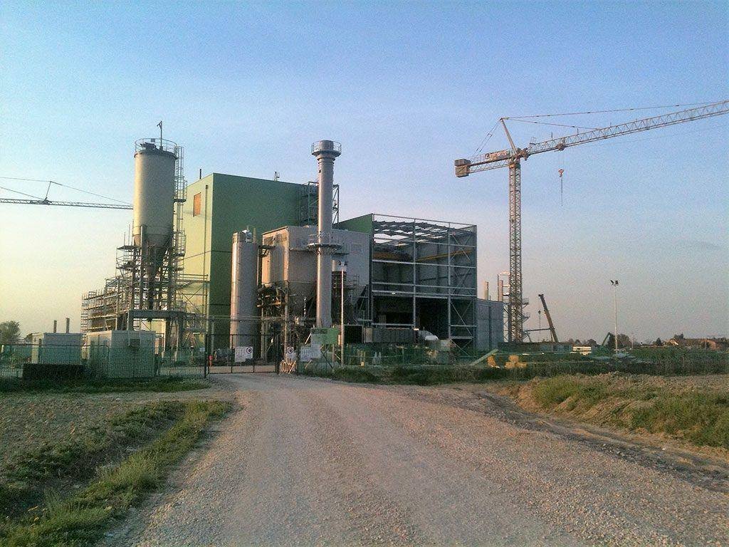 Waste-to-energy plant under construction with cranes